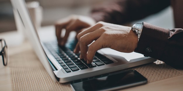A person using a laptop. Photo