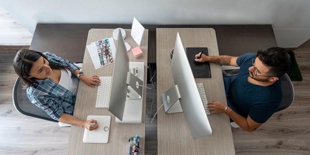 Two persons working at an office, photo.